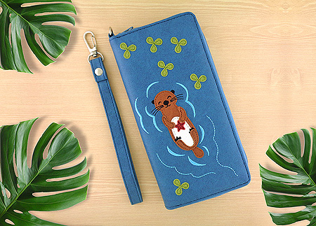 LAVISHY Adora collection wholesale floating sea otter holds a starfish applique vegan large wristlet wallets to gift shop, clothing & fashion accessories boutique, book store in Canada, USA & worldwide since 2001.